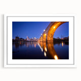 Extra large abstract art print of Minneapolis skyline in muted blue tones on a framed canvas, ideal for living room decor.