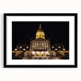 Colorful abstract art print of Kansas City skyline in vibrant hues on a framed black mat, ideal for living room decor.