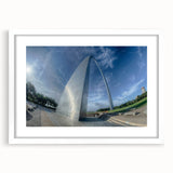 Abstract art print of St. Louis skyline in muted blue and gray tones on a framed white mat, ideal for dining room decor.