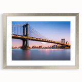 Textured art depicting the Manhattan Bridge in muted gray tones on a framed silver mat, ideal for modern bedroom decor.