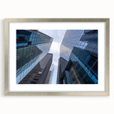 Textured art print depicting abstract New York City Wall Street scene in muted grays and silvers, framed in silver.