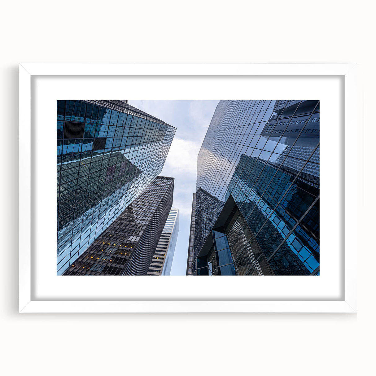 Abstract art print of Wall Street in muted grey and blue tones on a framed white mat, suitable for dining room decor.