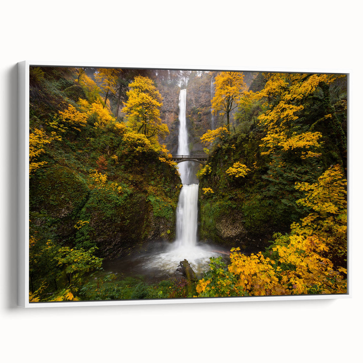 Vintage poster art of Multnomah Falls in Oregon, with vibrant green and blue tones on a framed canvas.