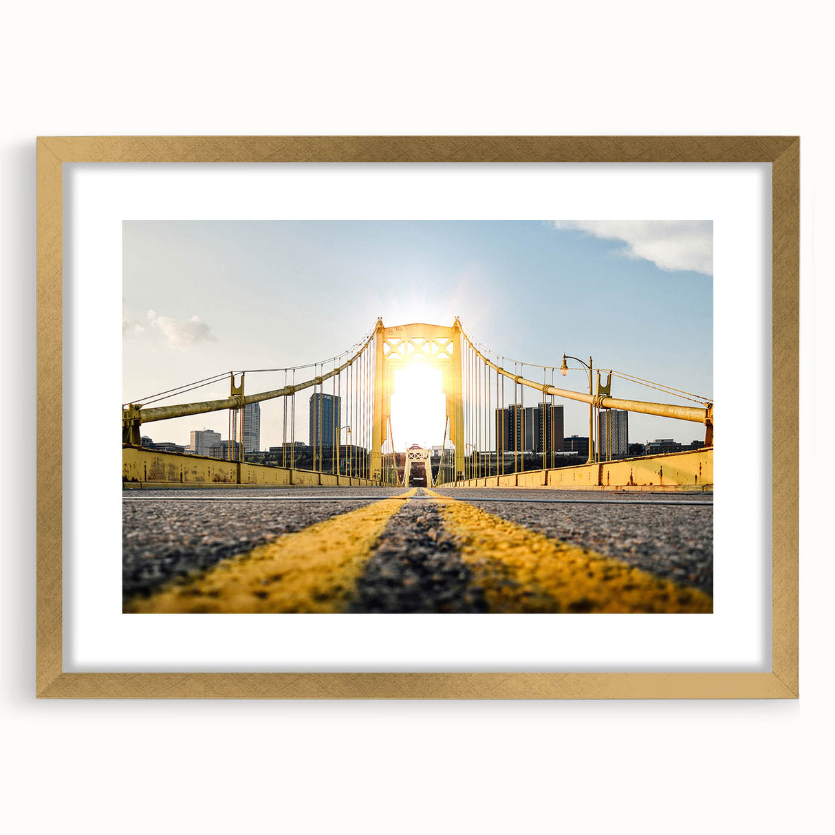 Abstract art print of Pittsburgh skyline in gold frame, featuring textured brush strokes in muted earth tones.