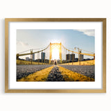 Abstract art print of Pittsburgh skyline in gold frame, featuring textured brush strokes in muted earth tones.