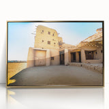 Mid-century modernist art depicting a Moroccan landscape in muted gold and blue tones on a framed acrylic print.