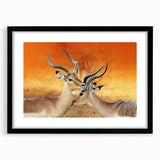 Colorful abstract art print of an African scenery in vibrant hues, framed in black, ideal for living room decor.