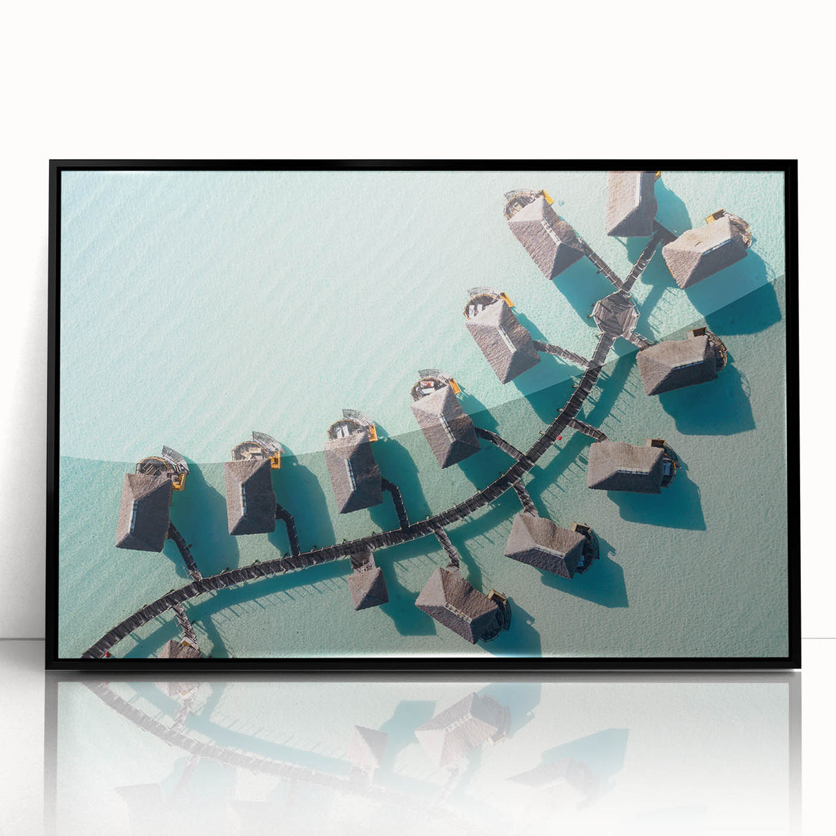 Large abstract wall art depicting the serene Maldives scenery in muted blue and green tones, framed in black acrylic.