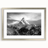 Textured art depicting abstract Mount Everest in muted earth tones on a framed silver mat, suitable for bedroom decor.