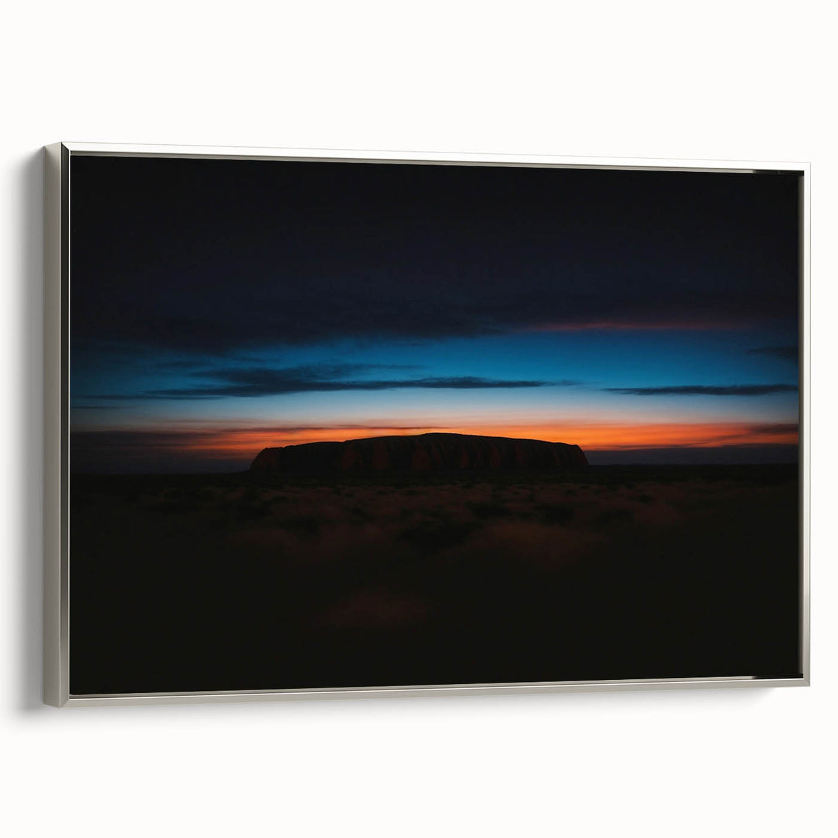 Vintage poster art of Ayers Rock on a framed canvas, featuring a colorful palette, ideal for living room decor.