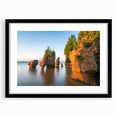 Abstract art print of a colorful, textured landscape, in a black frame with mat, ideal for living room decor.