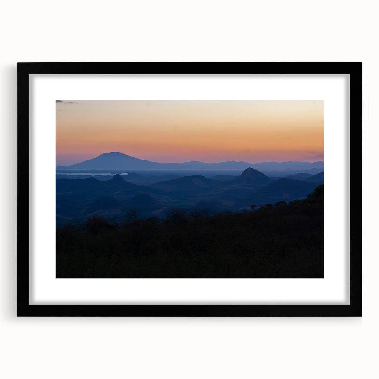 Extra large abstract art print of a colorful Central American landscape on textured canvas, framed in black.