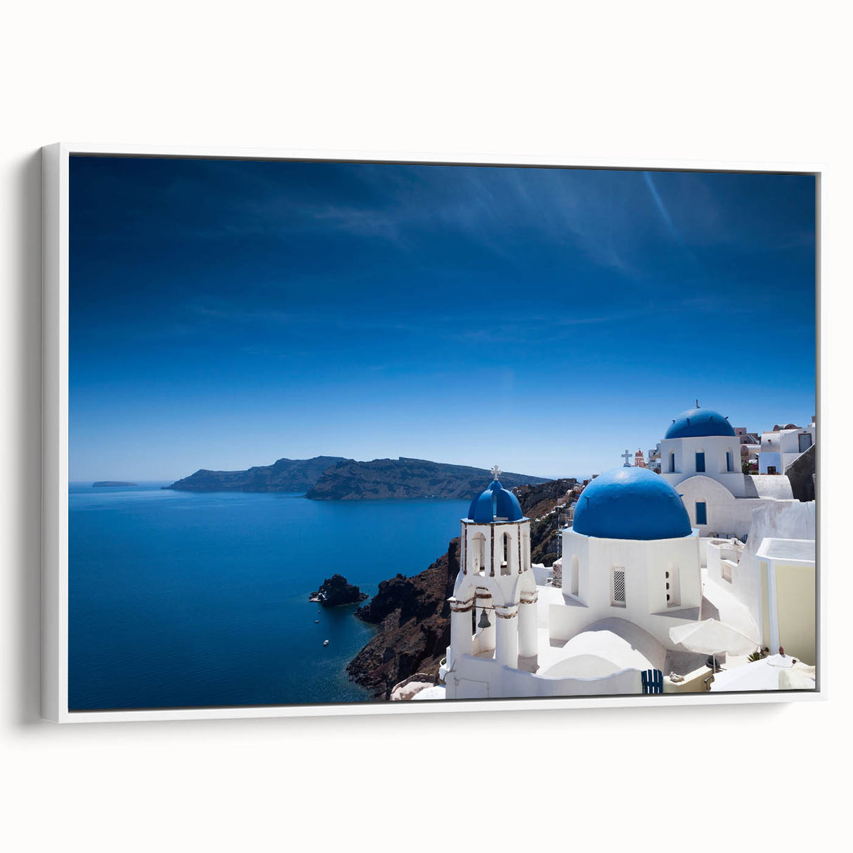 Vintage poster art of Santorini with vibrant blue and white tones on a framed canvas, suitable for living room decor.