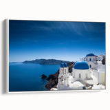 Vintage poster art of Santorini with vibrant blue and white tones on a framed canvas, suitable for living room decor.