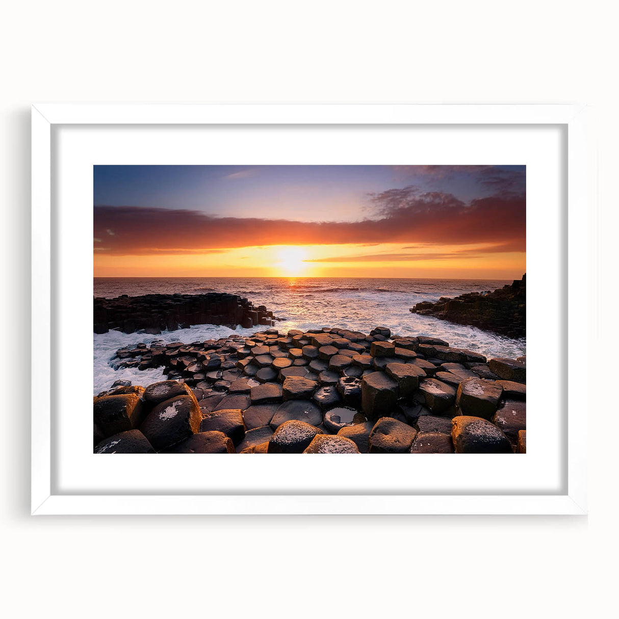 Textured art depicting abstract scenery of Northern Ireland in muted green and blue tones, framed with a white mat.
