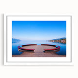 Abstract art print of Geneva scenery in muted blue and green tones, framed with a white mat, ideal for dining room decor.