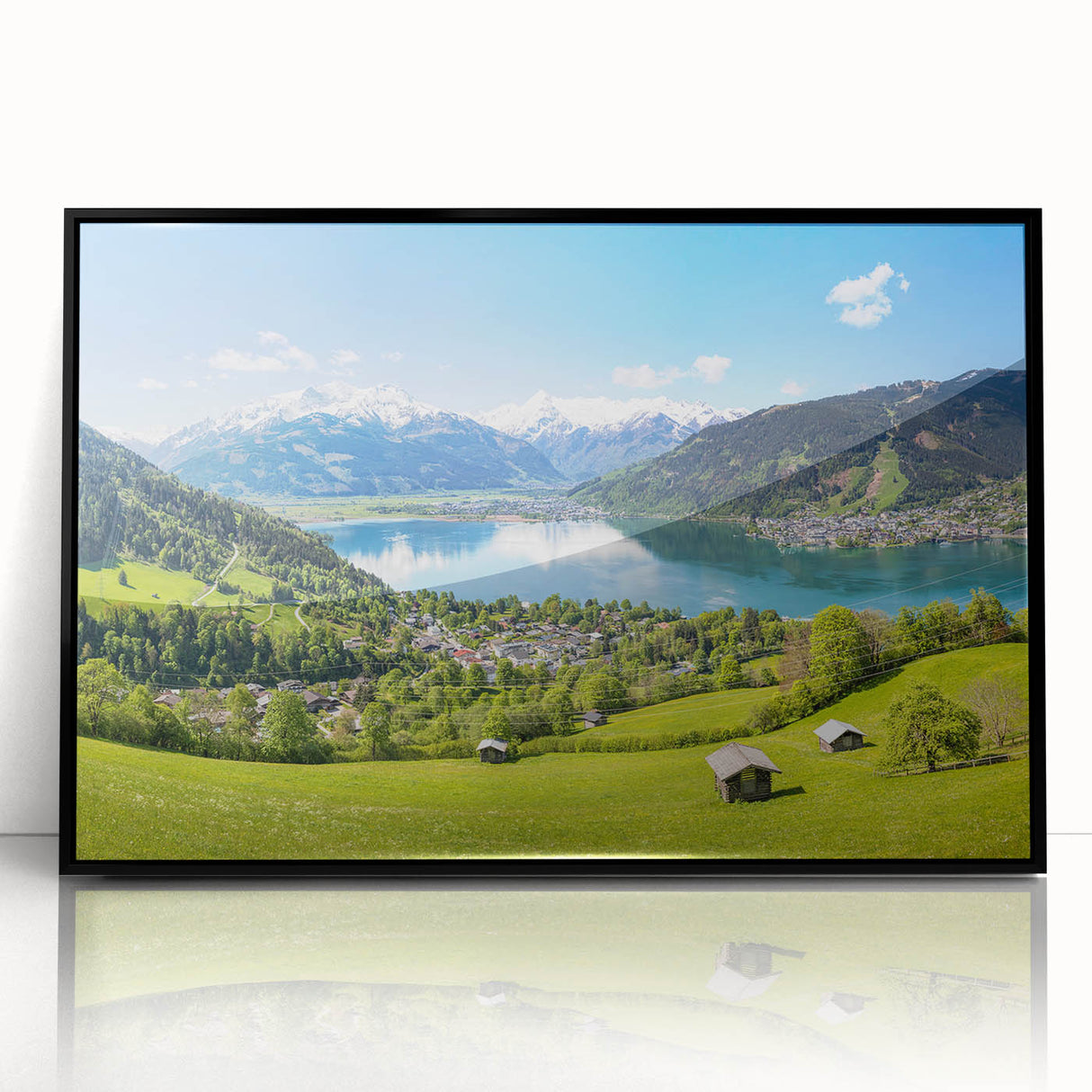 Large abstract wall art featuring a serene Swiss landscape in muted green and blue tones, framed in black acrylic.