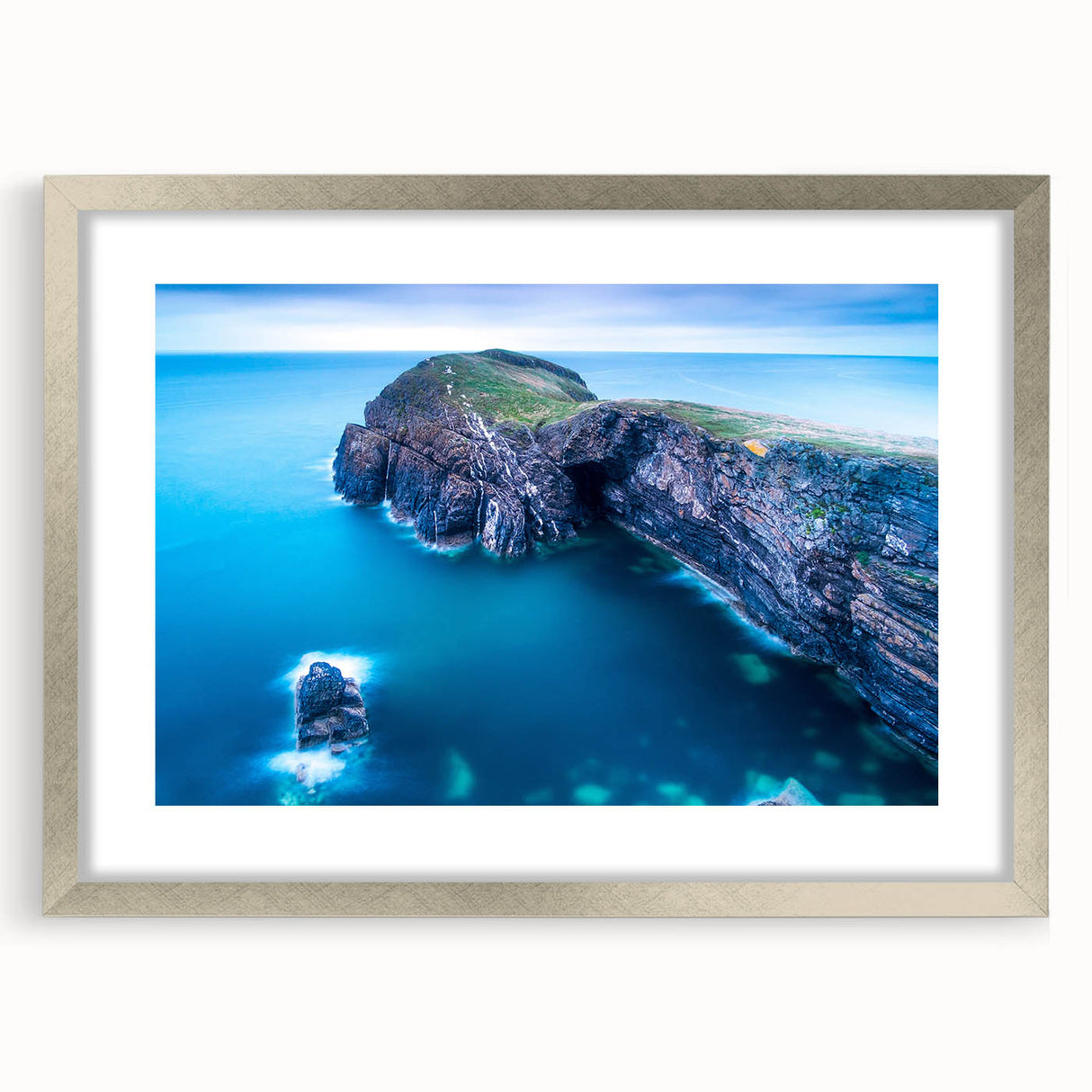 Textured art print depicting abstract Welsh scenery in muted earth tones, framed with a silver mat.