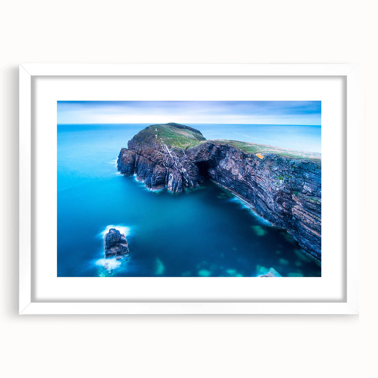 Abstract art print of a Welsh landscape in muted greens and blues on a framed white mat.