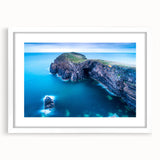 Abstract art print of a Welsh landscape in muted greens and blues on a framed white mat.