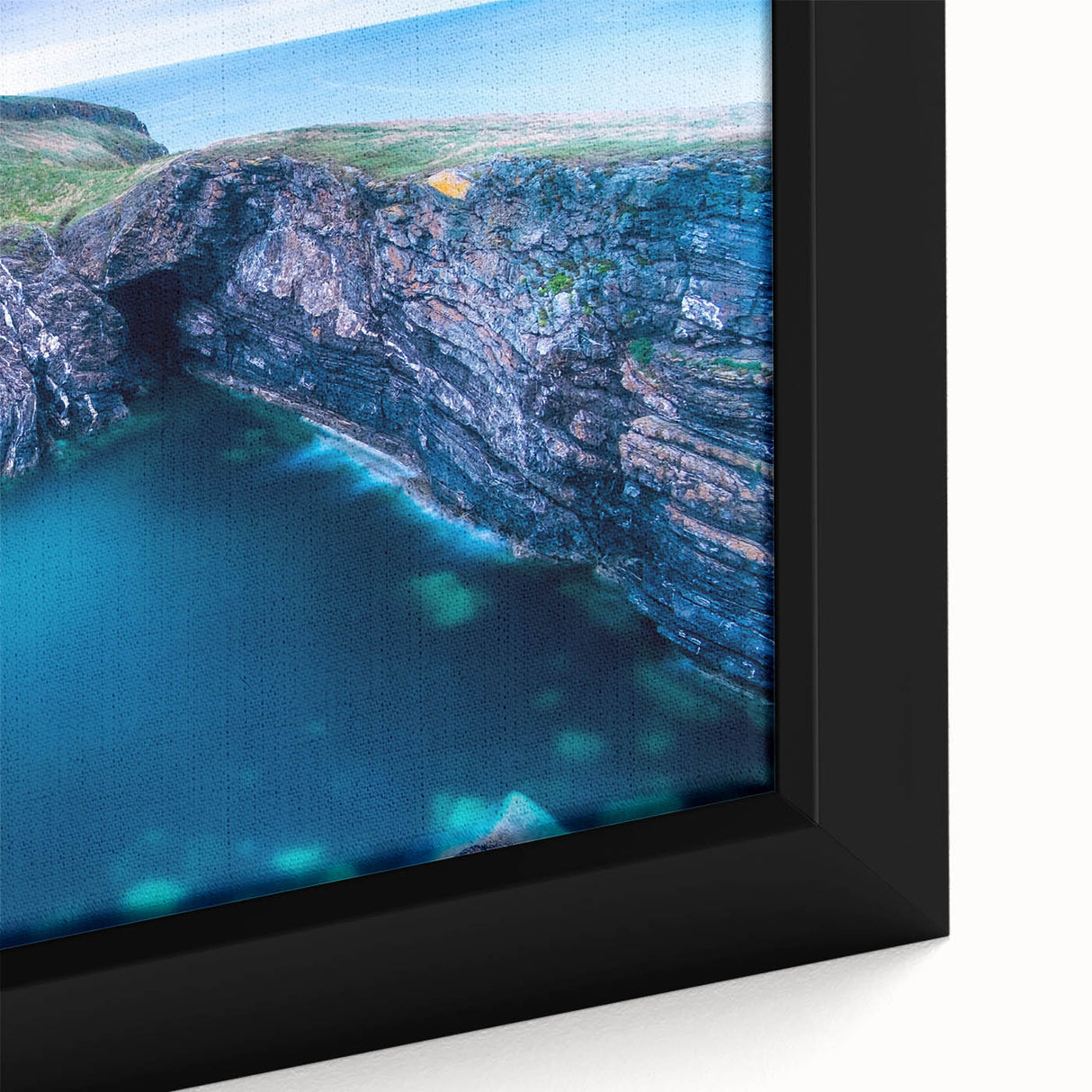 Close-up of textured black wall art featuring a colorful European scenery on a framed canvas, ideal for living room decor.