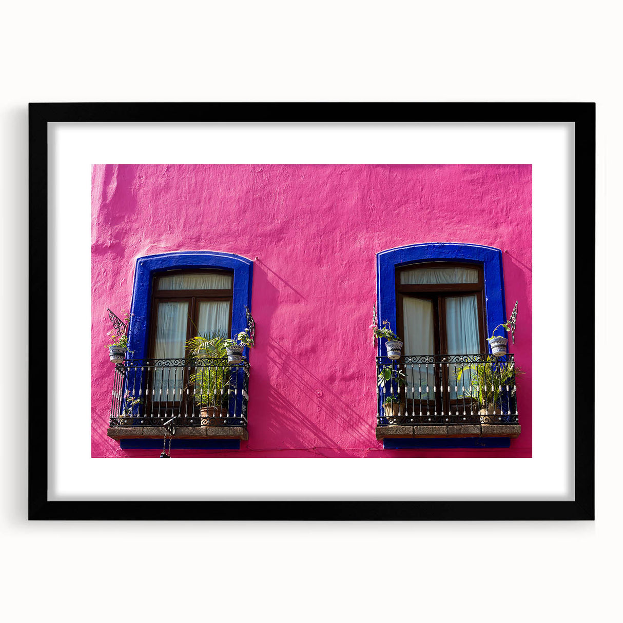 Extra large abstract art print featuring a colorful, textured depiction of Oaxaca scenery on a framed black mat.
