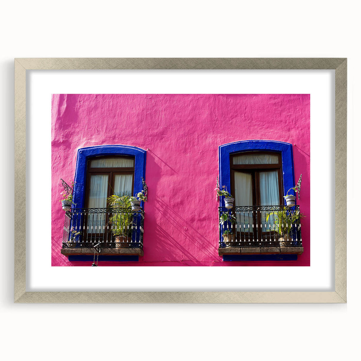 Textured abstract art print of Oaxaca scenery in muted earth tones, framed in silver, ideal for bedroom art.