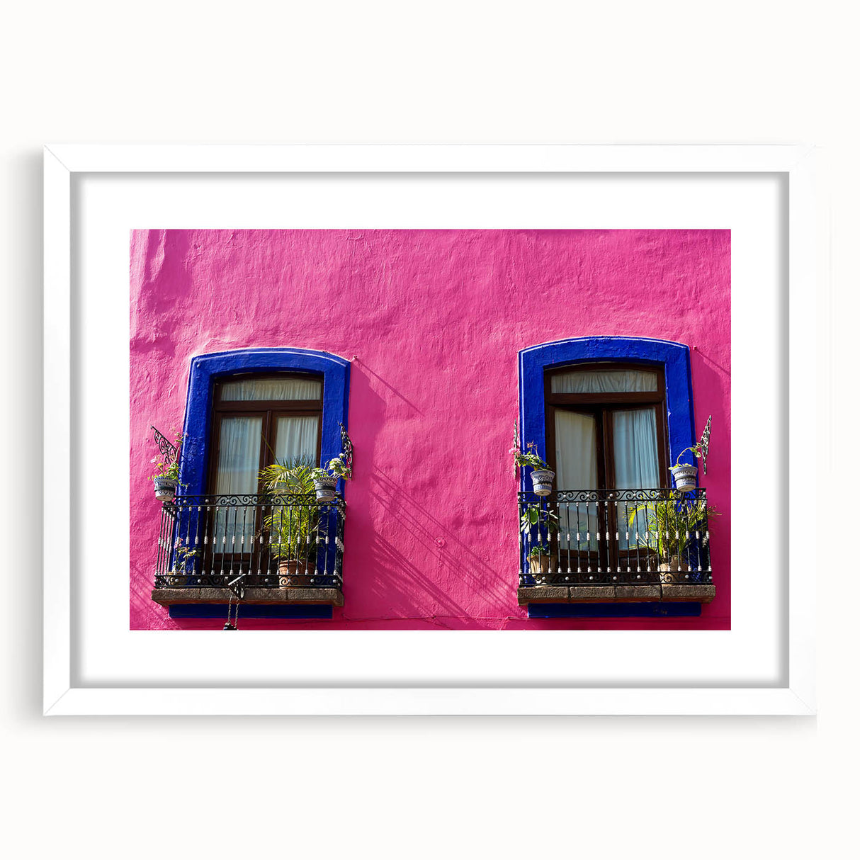 Abstract art print of Oaxaca scenery in muted earth tones, framed with a white mat, suitable for dining room decor.