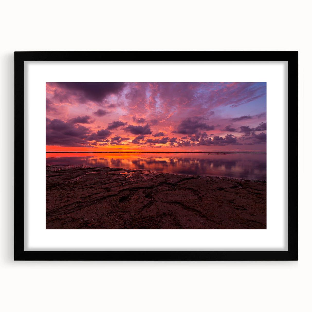 Colorful abstract art print of Santa Cruz scenery in a black frame, ideal for living room decor.