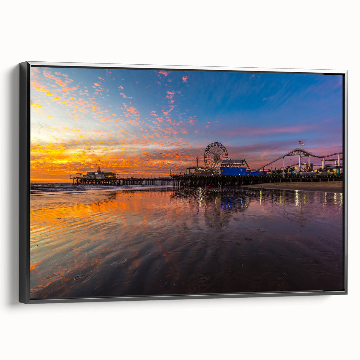 Black and white wall art featuring a vintage poster-style landscape of Santa Monica on a framed canvas.
