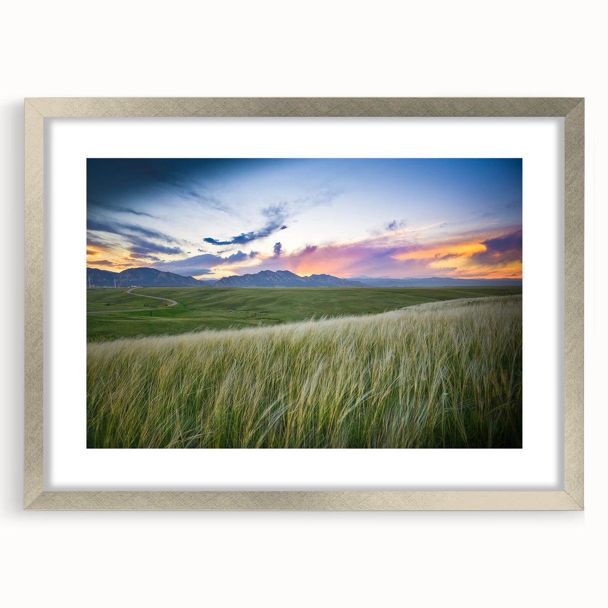 A textured art piece featuring abstract shapes in blue and grey tones on a framed silver canvas, ideal for bedroom art.