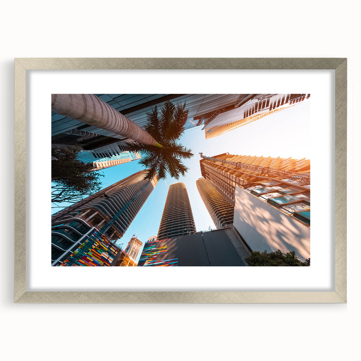 Textured art print of an abstract Miami skyline in cool blue and silver tones, framed in silver, ideal for bedroom art.