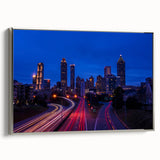 Framed canvas of Atlanta skyline in vintage poster style, featuring colorful art on a black background.