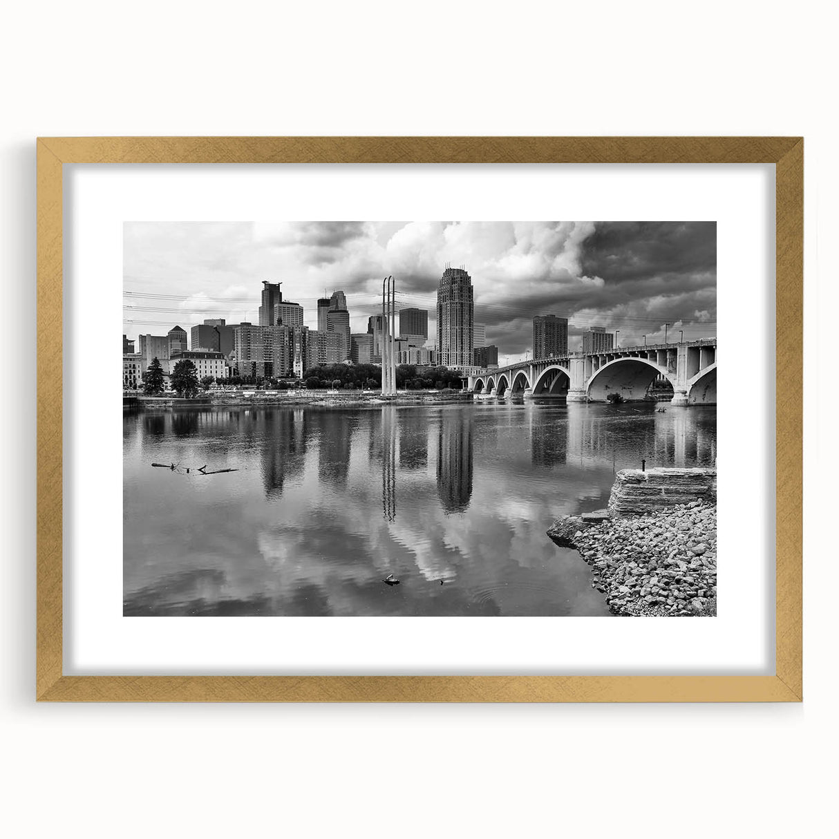 Extra large wall art of an abstract Minneapolis skyline in muted gold and blue tones, framed with a gold mat.
