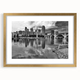 Extra large wall art of an abstract Minneapolis skyline in muted gold and blue tones, framed with a gold mat.