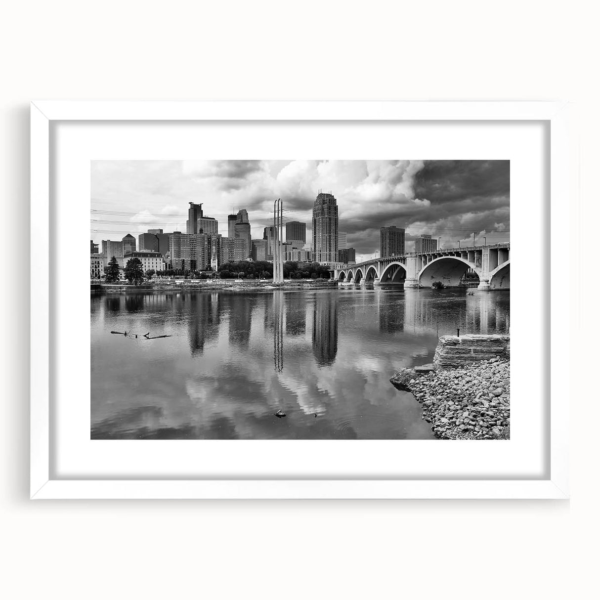 Abstract art print of Minneapolis skyline in muted gray and blue tones on a framed white mat, suitable for dining room decor.