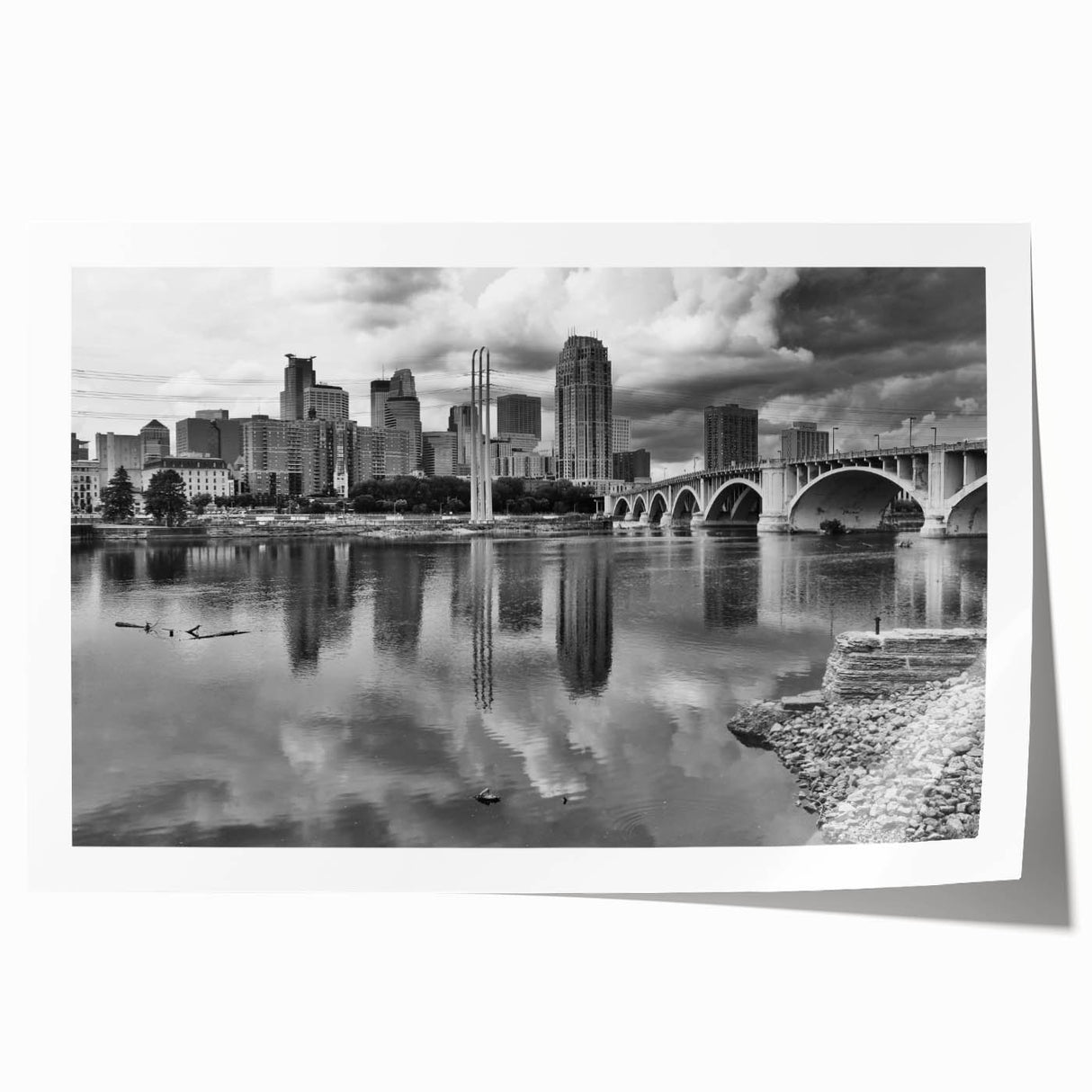 Rolled print wall art of the Minneapolis skyline in muted gray and blue tones, ideal for dining room decor.