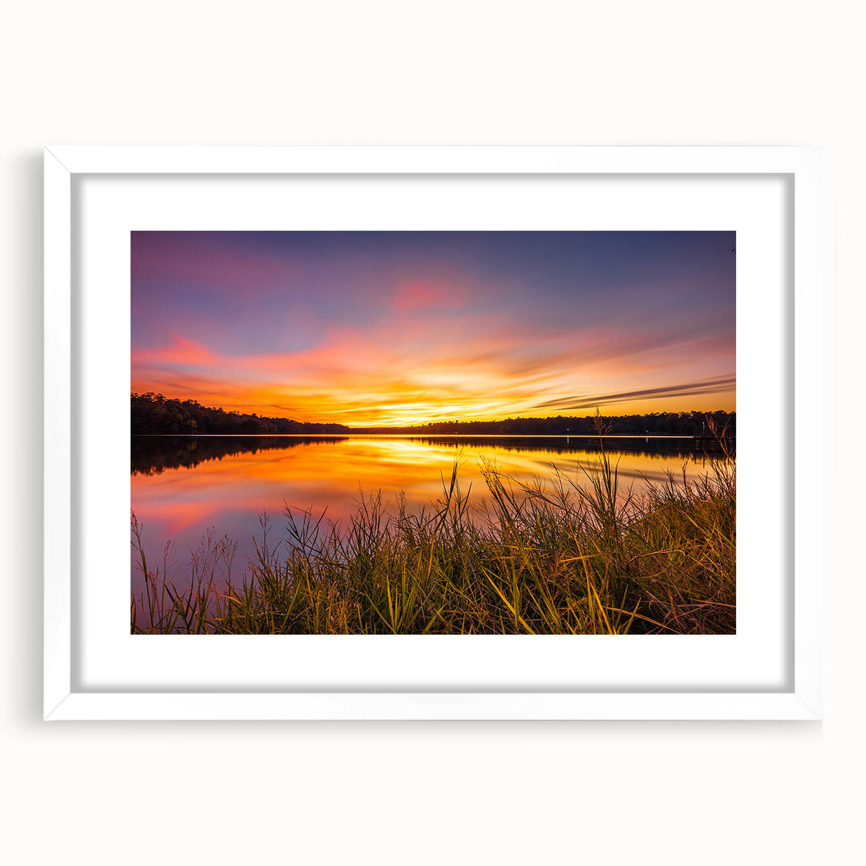 Abstract art print of a Mississippi landscape in muted blue and green tones on a framed white mat.