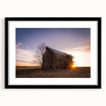 Colorful abstract art print of a textured Nebraska landscape in a black frame, ideal for living room decor.