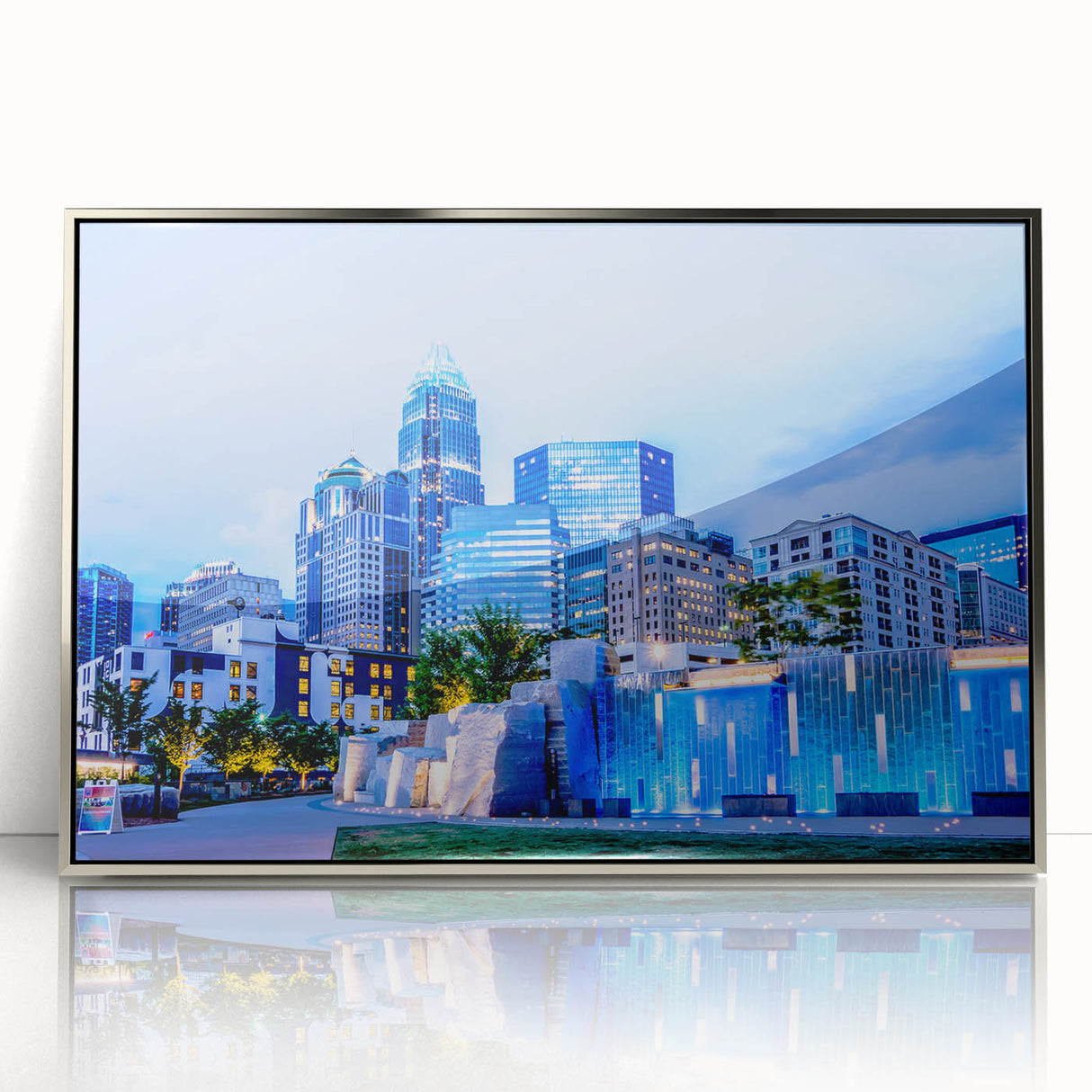 Mid-century modernist art depicting the Charlotte skyline in muted blue tones on a framed acrylic print.
