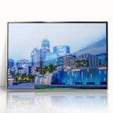 Mid-century modernist art depicting the Charlotte skyline in muted blue tones on a framed acrylic print.