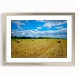 Textured abstract art print of Raleigh skyline in muted gray tones on a framed silver mat, suitable for bedroom decor.