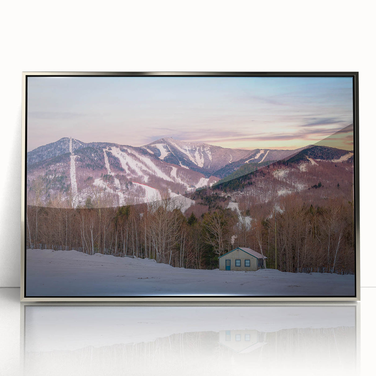 Mid-century modernist art depicting the Adirondacks in muted earth tones on a silver-framed acrylic.
