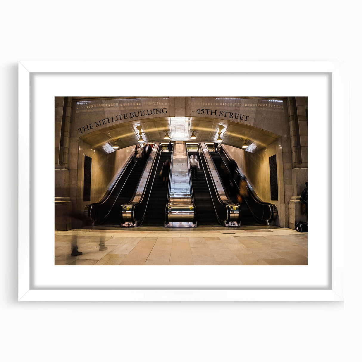 Abstract art print of NYC's Grand Central in muted gray and blue tones, framed with a white mat.