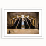 Abstract art print of NYC's Grand Central in muted gray and blue tones, framed with a white mat.