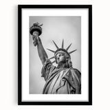 Abstract art print of the Statue of Liberty in muted green and blue tones on a framed black mat.