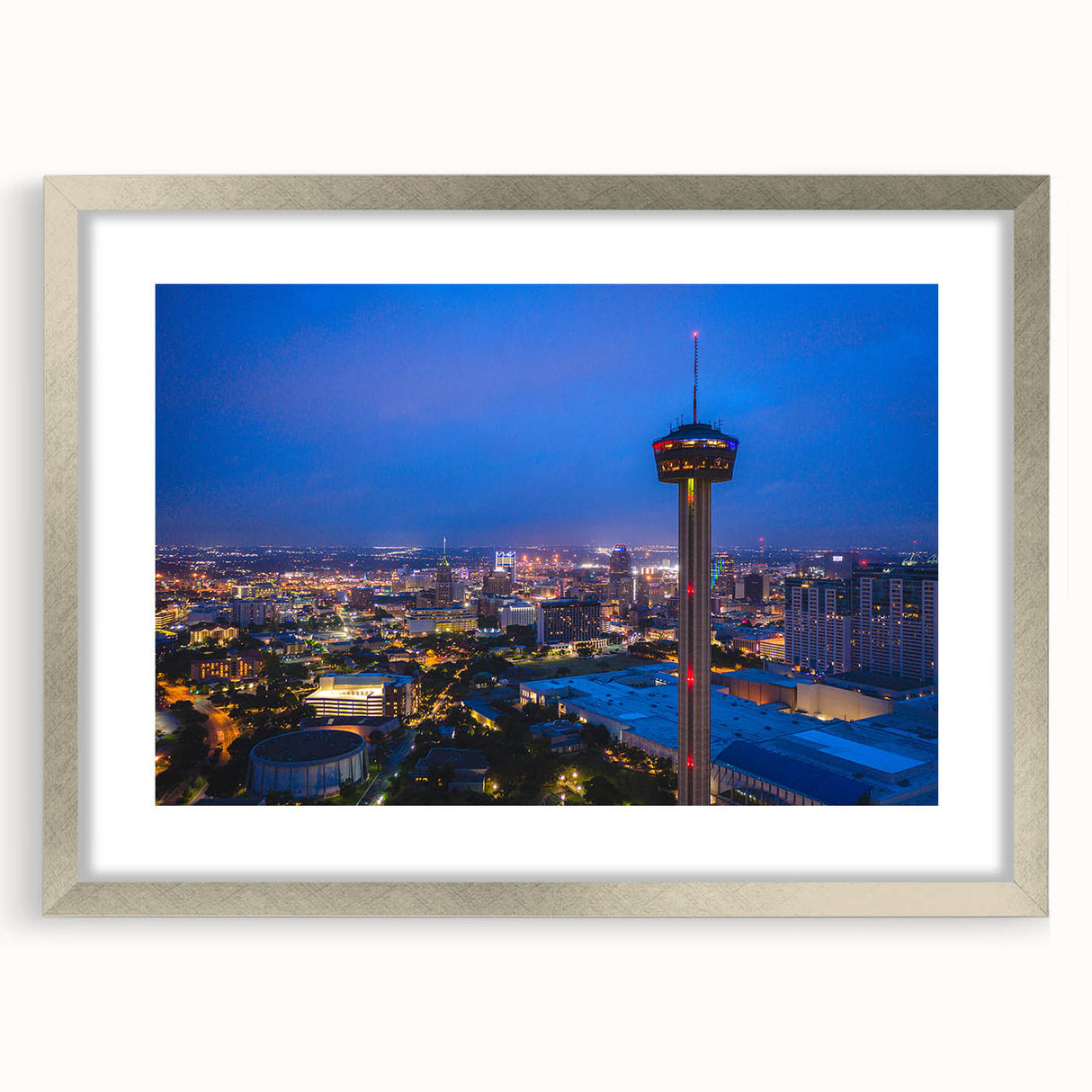 Textured abstract art print of San Antonio skyline in muted earth tones, framed in silver, ideal for modern bedroom ambiance.