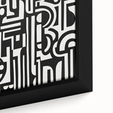 Close-up of an abstract geometric framed canvas artwork, showcasing intricate patterns in vibrant colors of blue, orange, and teal, ideal for modern decor.