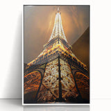 Art deco poster featuring geometric shapes in black and gold on a white acrylic frame.