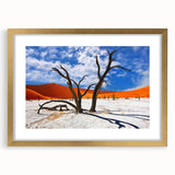 Textured abstract art print of an African landscape in muted earth tones, framed in gold, suitable for bedroom decor.